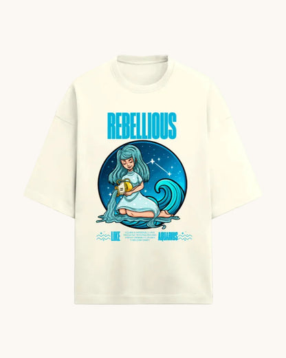 Beige t-shirt with a graphic design featuring a woman, a wave, and the word 'Rebellious' on a white background.