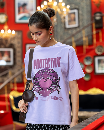 Woman wearing a Lavender t-shirt with a graphic design and text in a room with red walls and decorative elements.