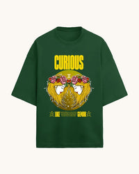 Green t-shirt with a graphic design featuring a face with flowers and the word 'Curious' on a white background.