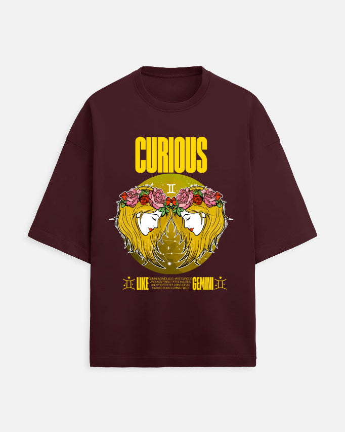 Maroon t-shirt with a graphic design featuring a face with flowers and the word 'Curious' on a white background.