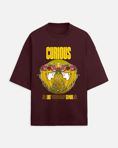 Maroon t-shirt with a graphic design featuring a face with flowers and the word 'Curious' on a white background.