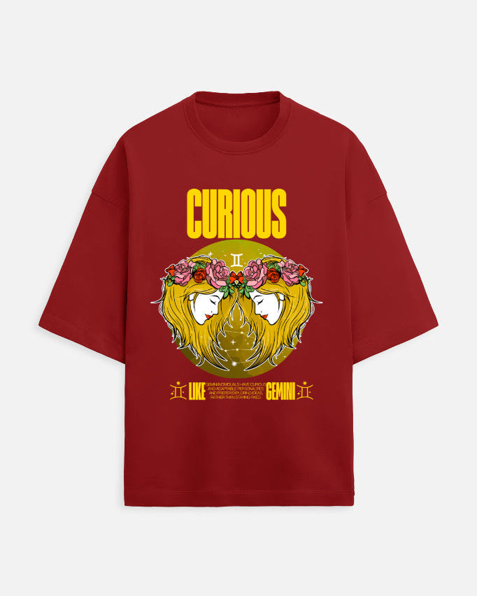 Red t-shirt with a yellow graphic design featuring a face with flowers and the word 'Curious'.