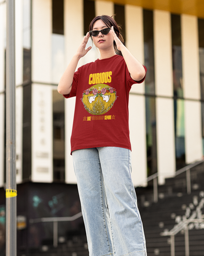 Person wearing a red t-shirt with a graphic design and text, standing outdoors.